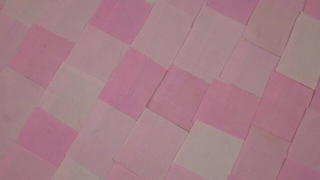 Handmade background in patchwork style with cotton fabric elements in pink tones