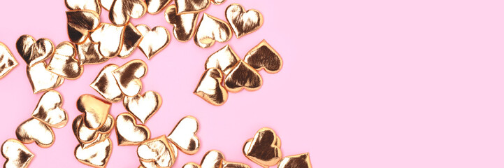 Banner with golden hearts confetti on a pink background. Place for text.