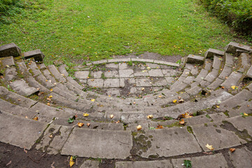 Old semicircular stone staircase in an abandoned park