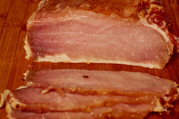 Pork tenderloin thinly sliced and prepared for schnitzel before cooking.