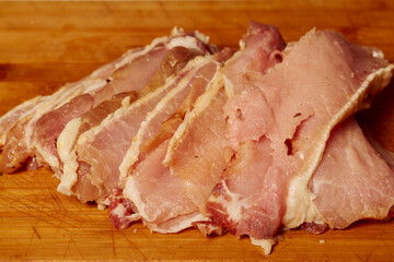 Pork tenderloin thinly sliced and prepared for schnitzel before cooking.