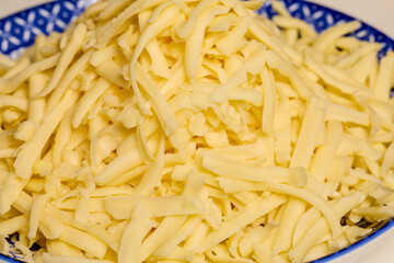 a plate with ready-to-use grated Mozzarella.