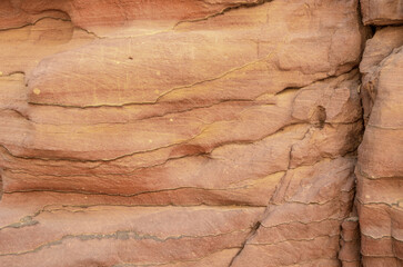 Naklejka premium texture of orange stone rock in a colored canyon close up