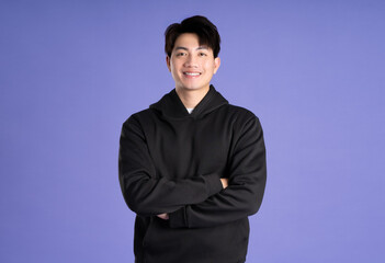 Asian male  posing on purple background
