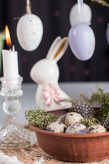 Easter quail eggs and Easter bunny. A bouquet of fluffy willow in a vase, the concept of an Easter holiday in the village