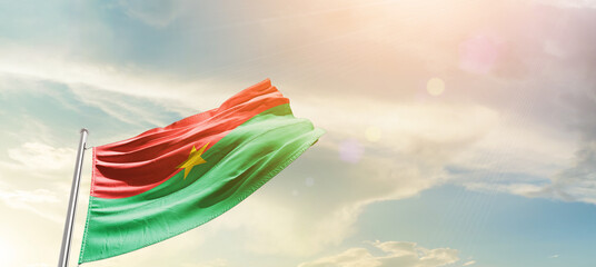 Burkina Faso national flag cloth fabric waving on the sky - Image