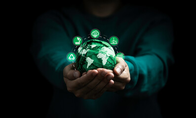 Businessman holding green scrap paper ball with world map and environment icon such as carbon reduction green factory recycle and solar cell for zero carbon emission credit to prevent global warming. - obrazy, fototapety, plakaty
