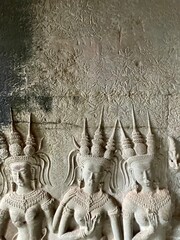 Carving of Cambodian Apsaras on Angkor Wat temple walls
