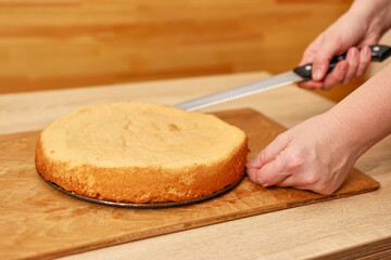 A freshly baked cake is cut in half. Cooking a festive pie at home