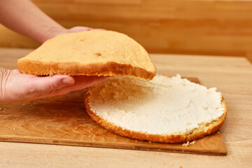 Adding the filling to the cake. Cooking a festive pie at home