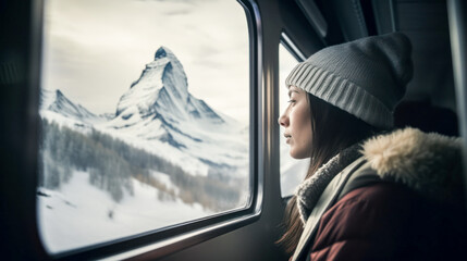 Traveler woman on the train looking out the window at the nice snowy mountains, travel concept, backpacking. Created with AI.