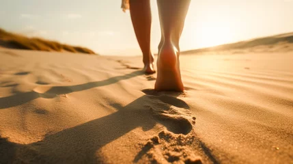 Fotobehang Woman's feet walking on the sand of the beach at sunset. travel concept. Created with AI. © Aida