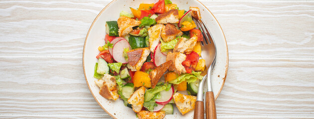 Traditional Levant dish Fattoush salad, Arab cuisine, with pita bread croutons, vegetables, herbs....
