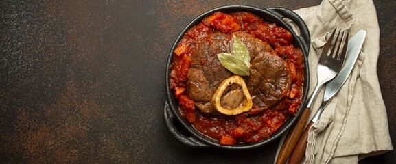 Traditional Italian dish Ossobuco all Milanese made with cut veal shank meat with vegetable tomato...