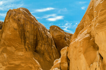 high rocky mountains against the blue sky and white clouds in the desert in Egypt Dahab South Sinai