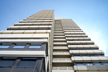 Tall office building with a blue sunny sky in the background