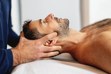 Gentle craniosacral therapy performed by an osteopath, targeting neck pain. - obrazy, fototapety, plakaty