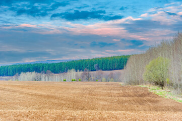 Sunsets provide a stunning backdrop to a plowed field. Experience the tranquility of rural life...
