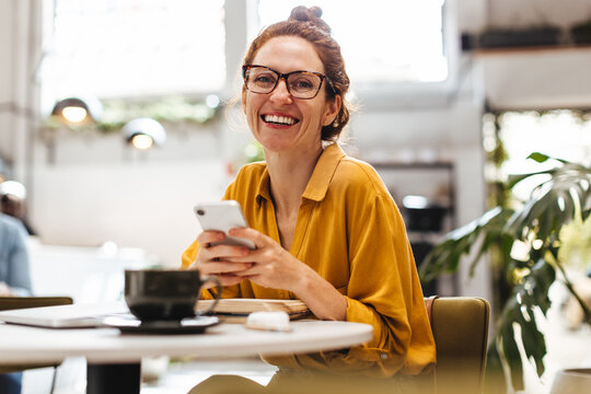 Professional woman using a mobile phone in restaurant
