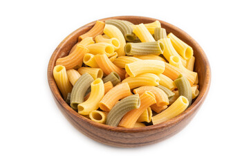 Rigatoni colored raw pasta in wooden bowl isolated on white. Side view.