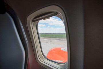 view from the airplane window to the blue sky and white clouds
