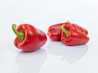 Three red bell peppers (paprika) isolated on white background