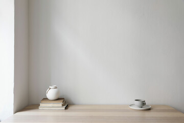 Modern interior, japandi home design. White vase, cup of coffee and old books on wooden table....