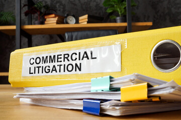 Yellow folder with commercial litigation documents.