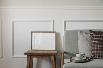 Elegant minimal Scandinavian interior. Blank horizontal wooden picture frame mockup on coffee...
