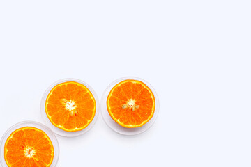 Vitamin C pills with  fresh orange citrus fruit isolated on white background.