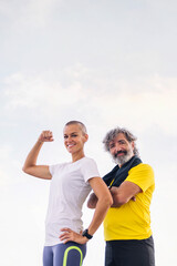 senior sportsman and young woman posing strong and confident looking at camera, concept of active and healthy lifestyle in the middle age, copy space for text