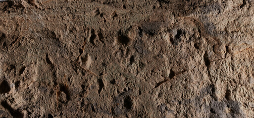 Brown stone texture, dark abstract background. Natural mineral rock close up details, empty backdrop with copy space for design