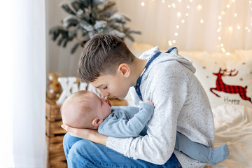 Happy family, newborn baby and older brothers, mom at home on Christmas