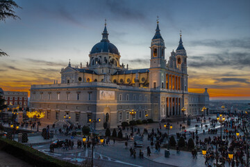 Fototapeta premium Madrid, Spain 28-12-2022 The Almudena Cathedral during a colorful sunset, it is the most important and Catholic religious building in Madrid and a visit is free of charge except for the crypt 