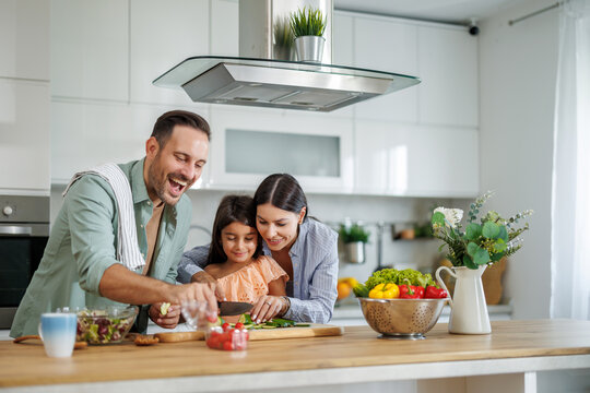 Happy family cooking together in kitchen