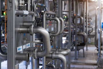 Industrial stainless steel pipework. Metal pipes, element of equipment design, of the milk production plant	