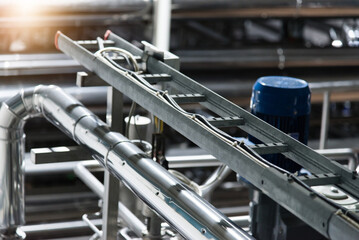 Industrial stainless steel pipework. Metal pipes, element of equipment design, of the milk...