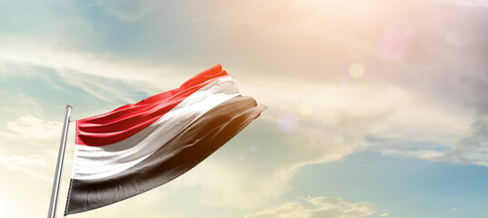 Yemen national flag cloth fabric waving on the sky - Image - obrazy, fototapety, plakaty