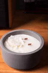 Handmade peonies scented candles in ceramic bowl with wooden wick and unusual design. Soy wax candles with wooden wick.