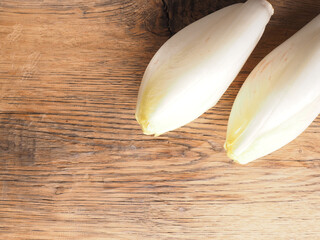 Tasty chicory on a wooden kitchen table, view from above