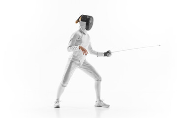 Female athlete in fencing gear showcasing her impeccable form, sword poised for action against...