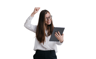 Expressive young businesswoman in glasses, shirt and black pants holding tablet making video call rising fist up against transparent background, celebrating great deal, laughing, screaming