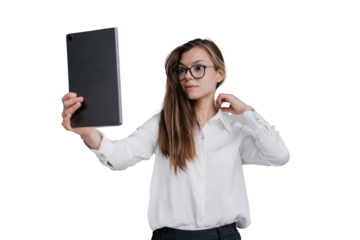 Attractive caucasian woman in white shirt holds tablet, uses like a mirror, males selfie against transparent background , new spectacles. businesswoman preparing for video call