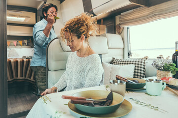 Couple in camper relaxing preparing lunch and enjoying free time