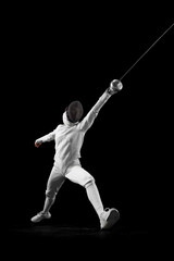Fototapeta na wymiar Dynamic portrait of female fencer lunges forward, her blade poised to strike, she closing in fast against black studio background. Concept of professional sport, active lifestyle, championship. Ad
