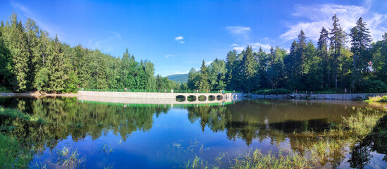 panoramic view to Dam on the Lomnica River, semicircular dam with five overflows in Karpacz, Poland