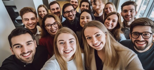 Fototapeta premium Group of young coworkers taking selfie during break. Team bonding.