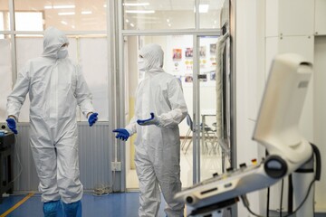 Technician engineers check robot arms and repair automatic robotic machines at the industrial factory, Workers working with focused repairing robotic arms in the industry.