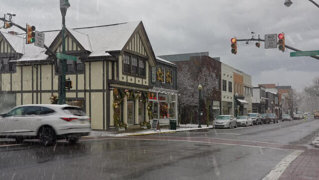 A snowy daytime establishing shot of a small New England town's business district decorated for Christmas. Pittsburgh suburbs.  	