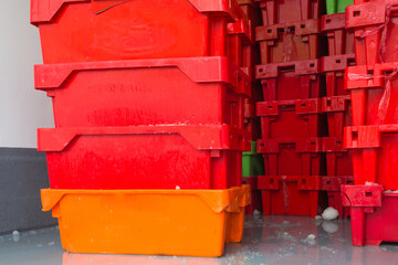 stacked red plastic packing crates in the back of a refrigerated truck or vehicle concept food...